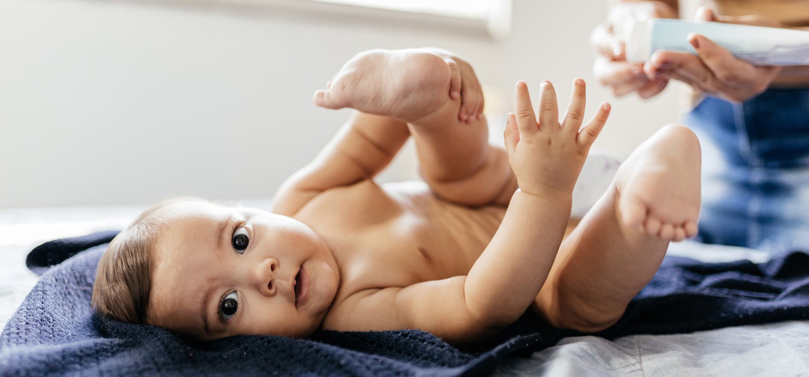 Mother changing baby's diaper